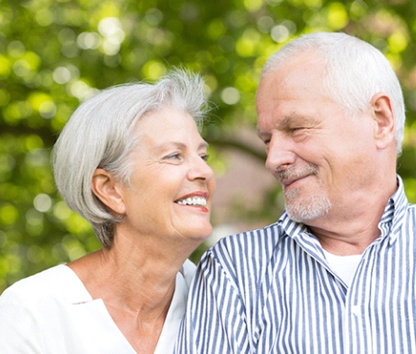 Senior woman with dentures in Wauwatosa smiling at her husband